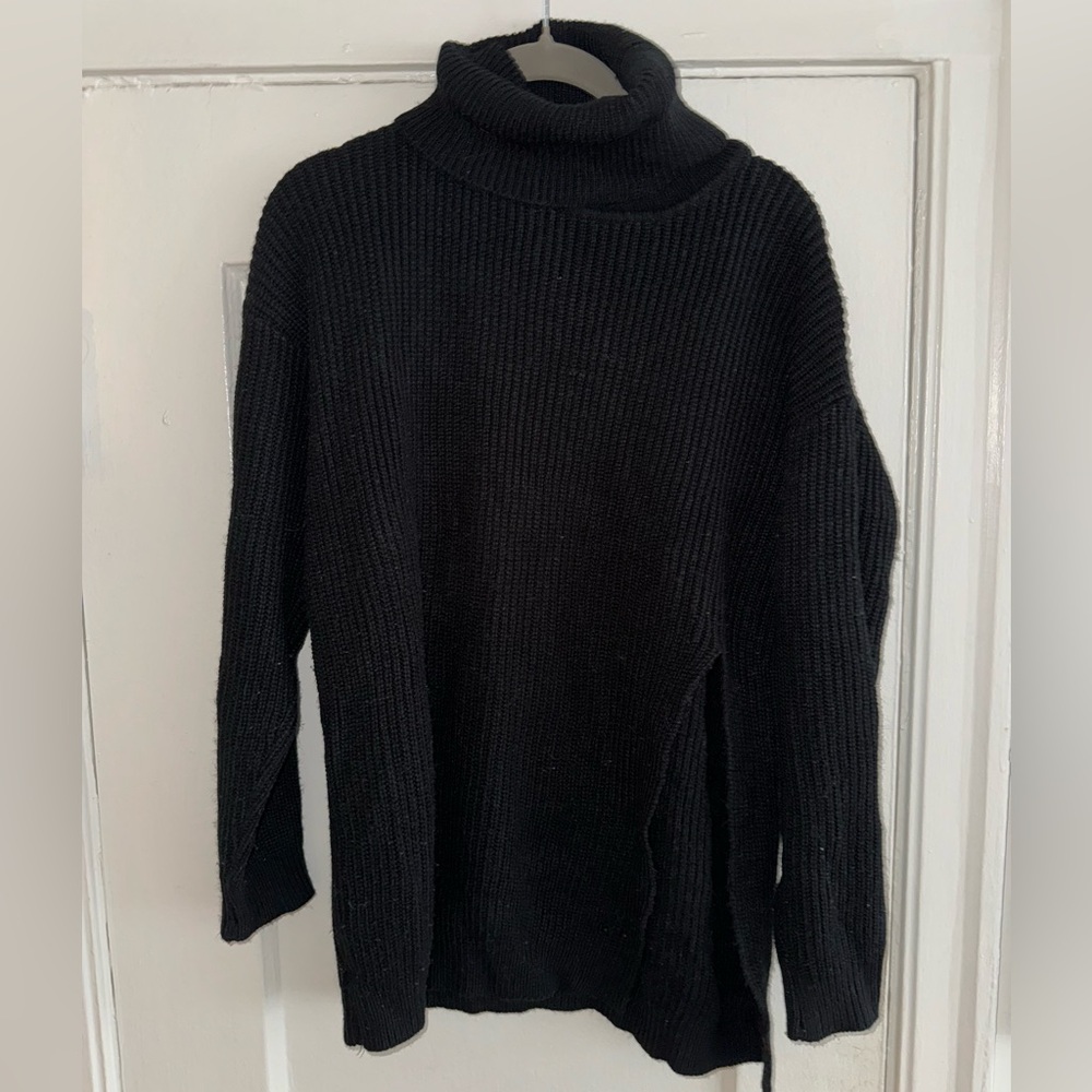 Black turtle neck sweater with a slit on one side